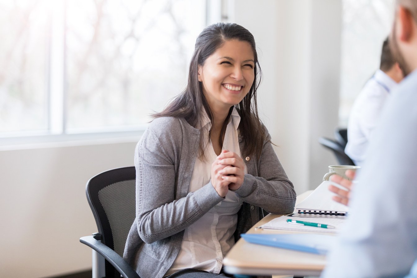 Smiling businesswoman interviews job candidate